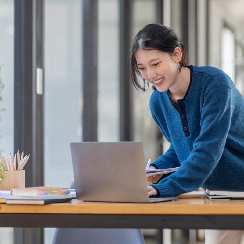business-asian-woman-using-laptop-computer-and-working-at-of